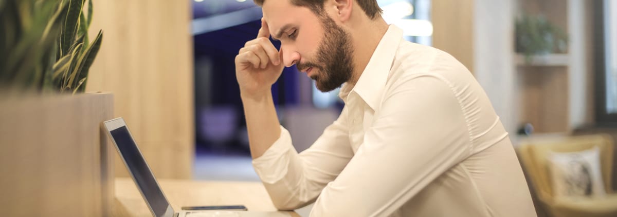 man concentrating over laptop Cape Cod Uncontested Divorce and mediation